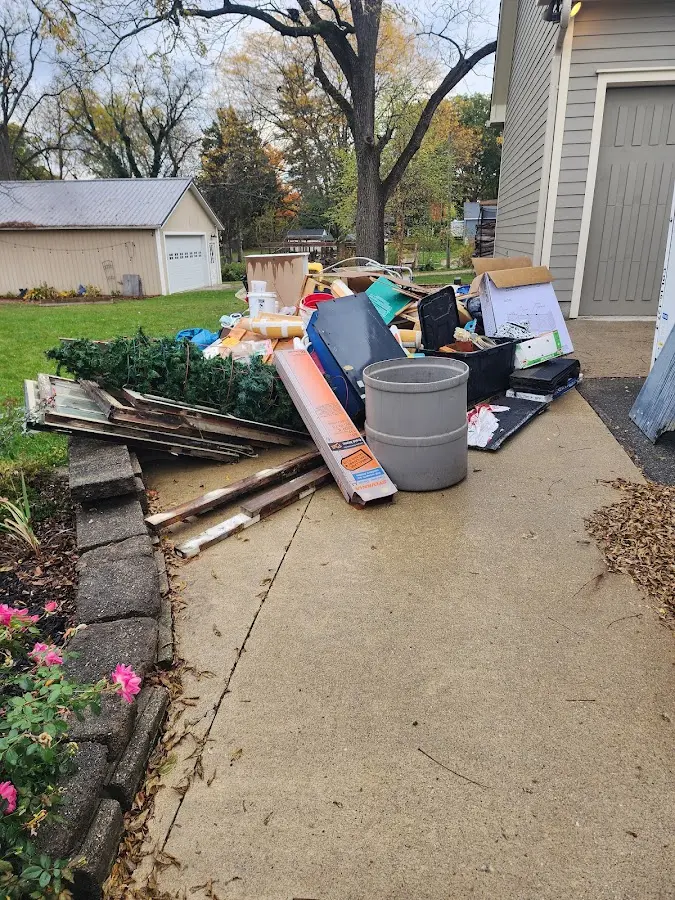 Dumpster being loaded with debris for 10 Yard Dumpster Rental in Oak Grove